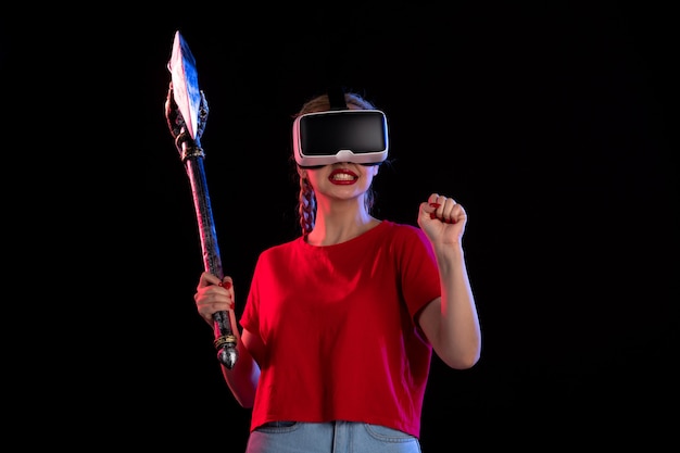 A first-person perspective inside a VR game, showing a player character holding a futuristic weapon in a vibrant, alien environment.