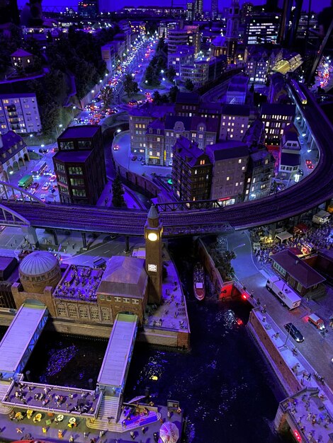 A vibrant cityscape at night, featuring neon lights, bustling streets filled with pedestrians, and flying vehicles, all rendered in high detail from an upcoming open-world game in 2025.