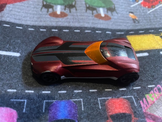 An in-game screenshot showing a player customizing their Rocket League car with various cosmetic items such as decals, wheels, and a hat. The car is brightly colored with a unique design.