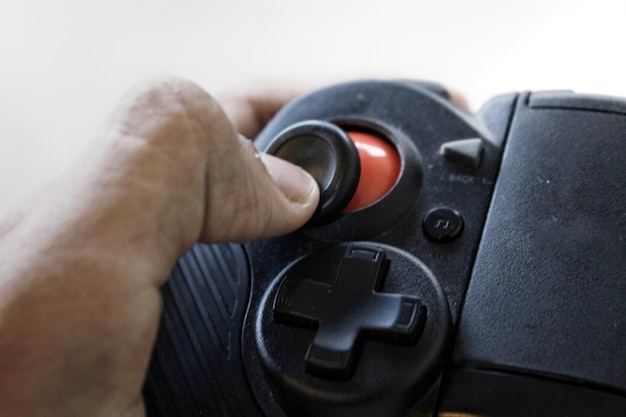 A close-up, detailed shot of a game controller with fingers pressing buttons, highlighting the precision and skill required to play  effectively. The background should be blurred to focus on the controller and hands.