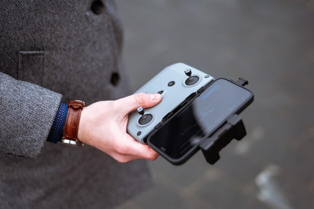 Close-up of the hands holding the Steam Deck, showing the ergonomic design and the placement of buttons and joysticks ideal for long gaming sessions. The background is a gamer's desk with headphones and ambient lighting.