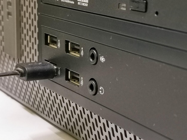 A close-up shot of a game console's rear panel showing various ports and cables connected, highlighting the physical connections needed for backward compatibility.