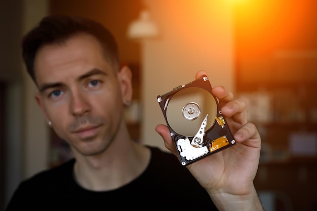 A close-up of a person installing an NVMe SSD into a PlayStation 5, highlighting the ease of access and installation process.