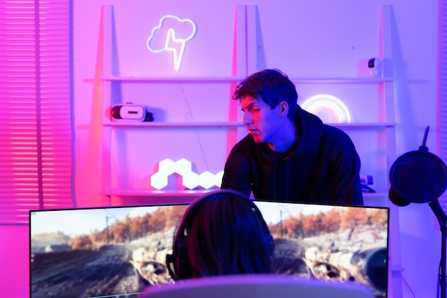 A gamer using a high-performance gaming PC with dual monitors, showcasing an immersive gaming experience with vivid graphics.