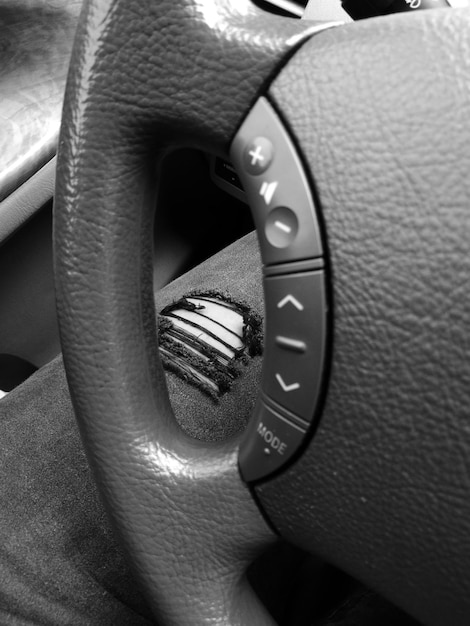 Close-up of the steering wheel rim with detailed texture and stitching, showing the high-quality materials used in its construction. The focus is on the feel and grip of the wheel.